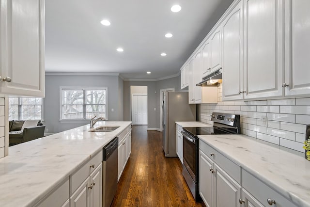 kitchen featuring light stone countertops, stainless steel appliances, sink, dark hardwood / wood-style floors, and white cabinetry