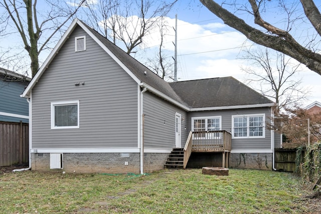 rear view of property with a lawn and a deck