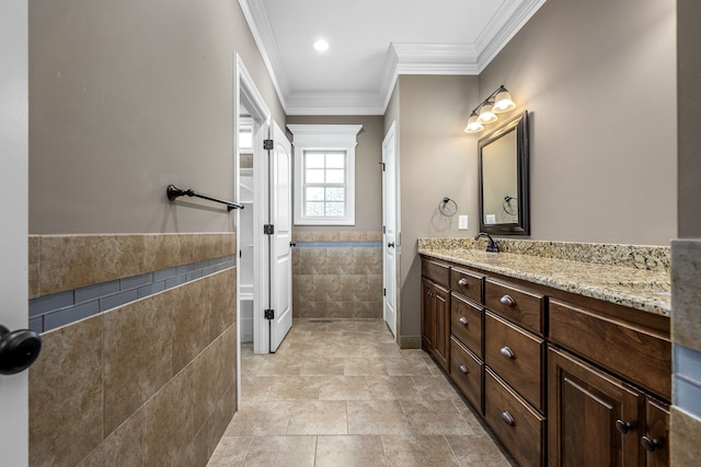 bathroom with tile patterned flooring, vanity, and crown molding