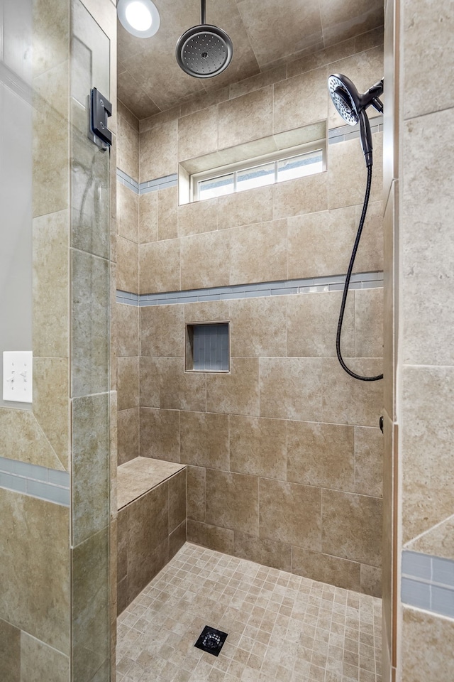 bathroom with a tile shower