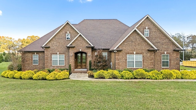 view of front of home featuring a front lawn and french doors