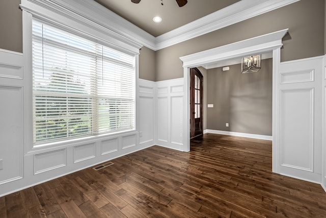 unfurnished room with dark wood-type flooring, ceiling fan with notable chandelier, and ornamental molding