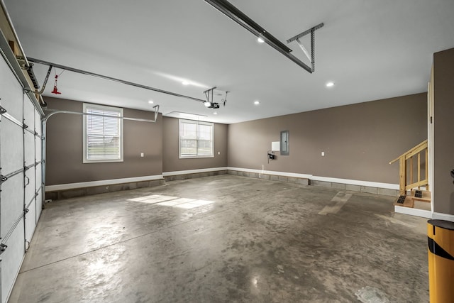 garage featuring electric panel and a garage door opener