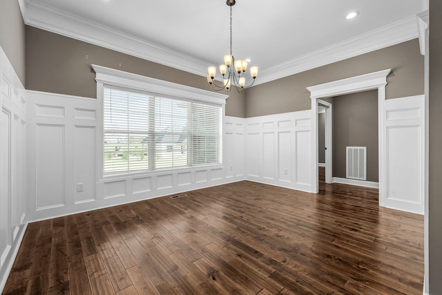 unfurnished dining area featuring dark hardwood / wood-style flooring, a chandelier, and ornamental molding