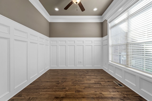 spare room featuring dark hardwood / wood-style floors, ceiling fan, and ornamental molding