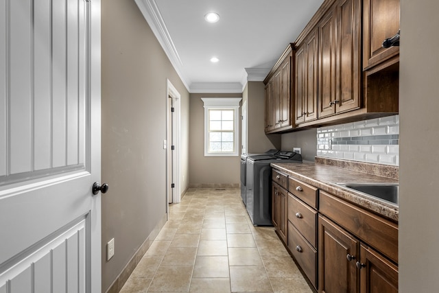 laundry room with sink, cabinets, independent washer and dryer, light tile patterned floors, and ornamental molding