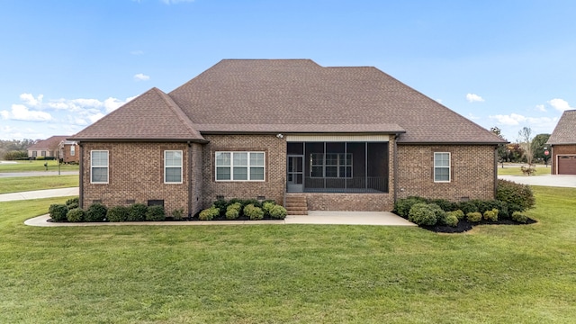 back of house with a sunroom and a yard