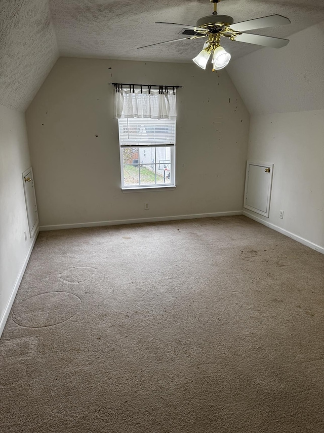 bonus room with ceiling fan, light colored carpet, lofted ceiling, and a textured ceiling