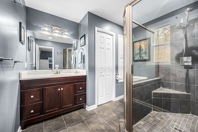 bathroom with tile patterned flooring, vanity, and an enclosed shower