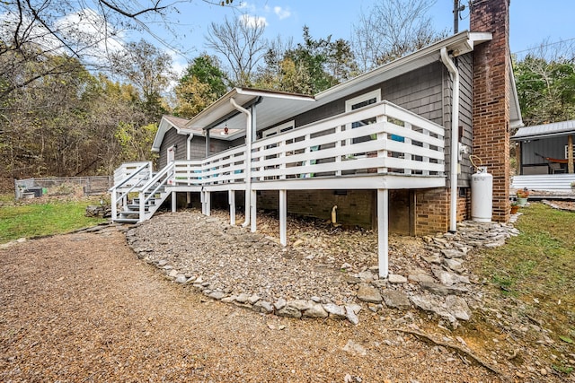 back of property featuring a wooden deck