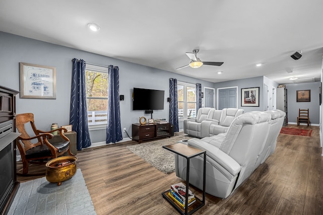 living room with plenty of natural light, dark hardwood / wood-style floors, and ceiling fan