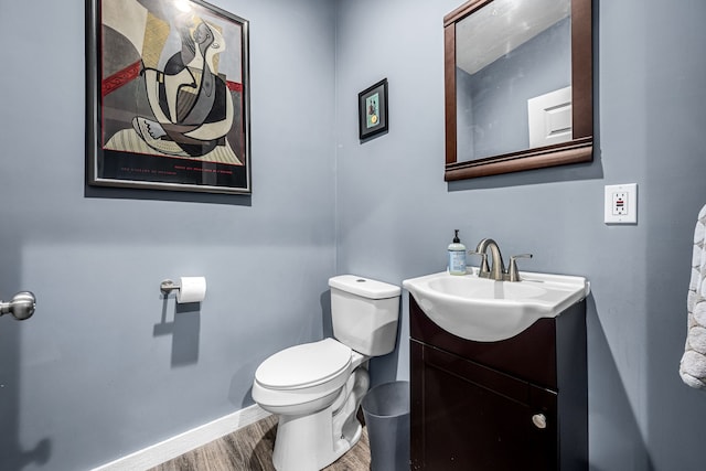 bathroom featuring hardwood / wood-style flooring, vanity, and toilet