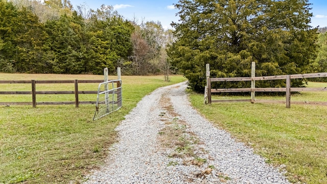 view of gate featuring a rural view and a yard