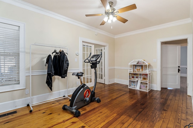 exercise area featuring dark hardwood / wood-style floors, ceiling fan, and ornamental molding