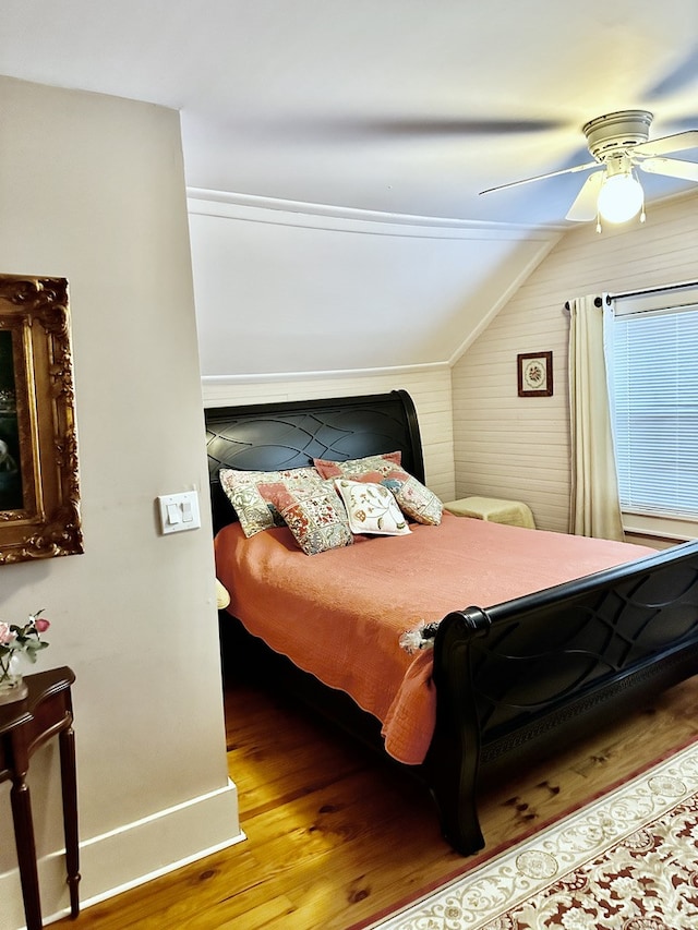 bedroom with ceiling fan, wood-type flooring, and vaulted ceiling