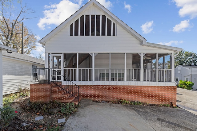 rear view of house featuring a sunroom