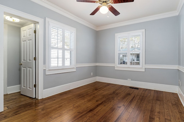 spare room with plenty of natural light, dark wood-type flooring, and ornamental molding