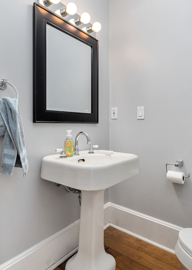 bathroom with hardwood / wood-style floors and toilet