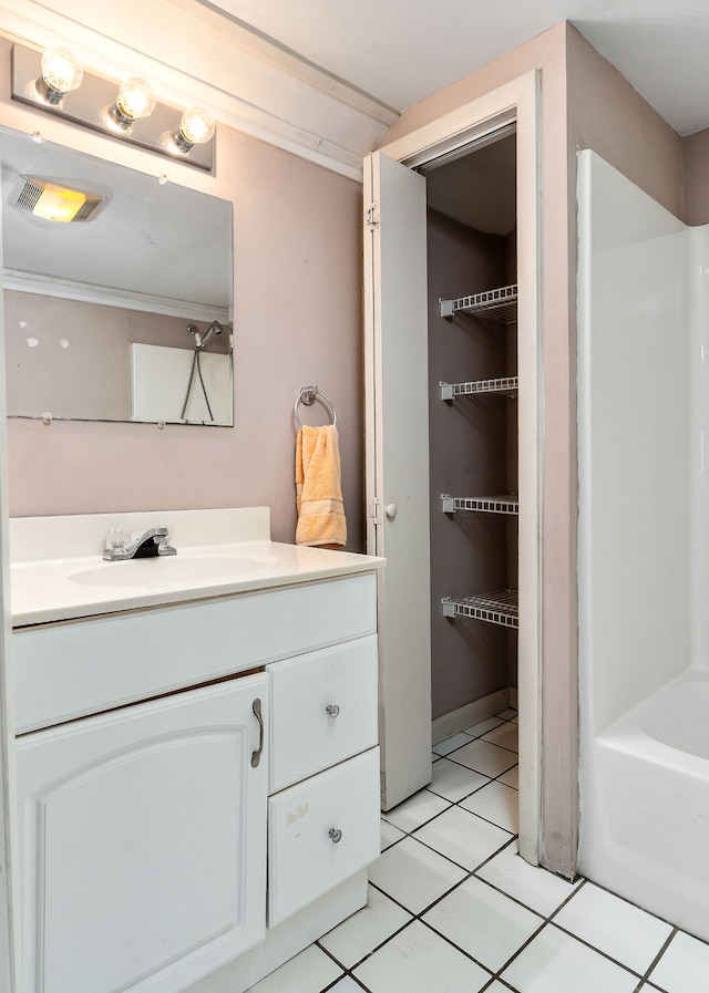 bathroom with shower with separate bathtub, vanity, and tile patterned floors