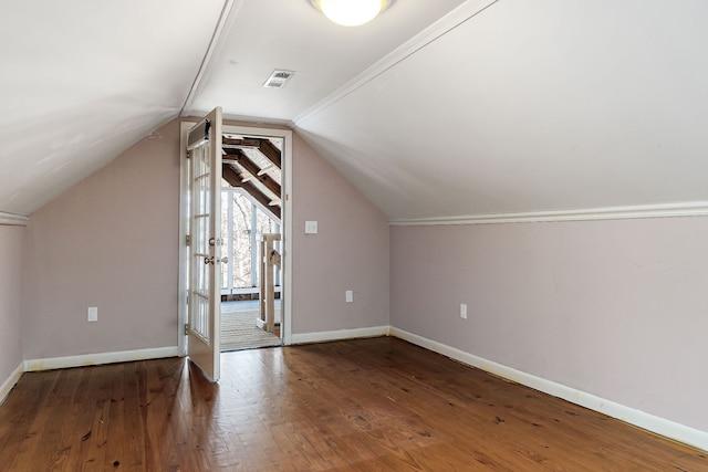 bonus room featuring dark hardwood / wood-style floors and vaulted ceiling