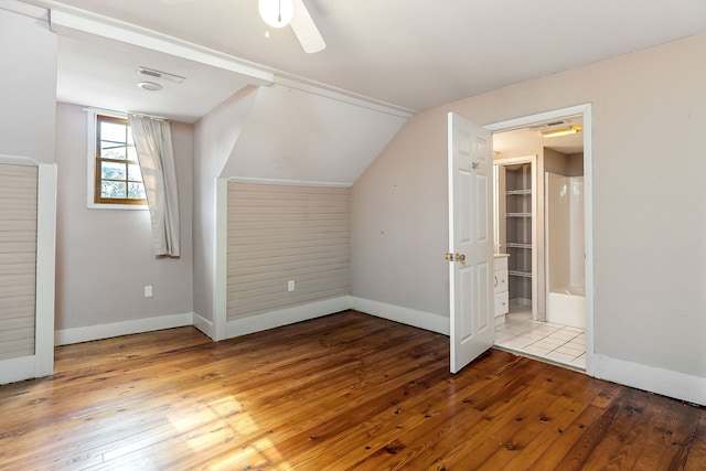 additional living space with lofted ceiling, ceiling fan, and wood-type flooring