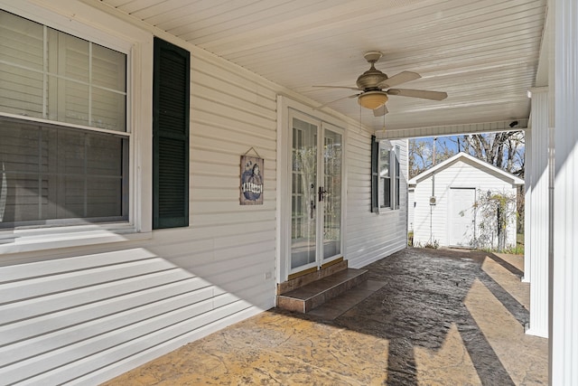 view of patio featuring ceiling fan and a shed