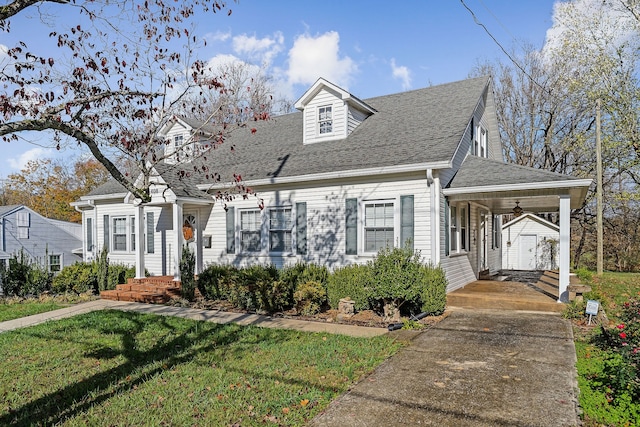 cape cod-style house with an outbuilding, a front lawn, and ceiling fan