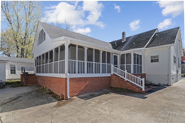 view of front of home featuring a sunroom