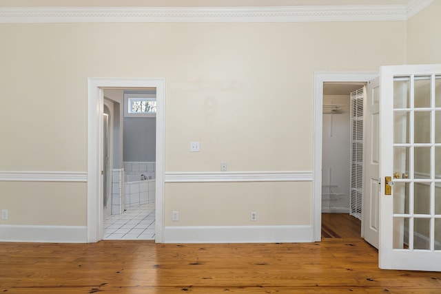 spare room with wood-type flooring and ornamental molding