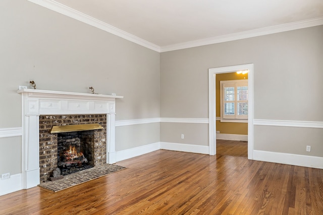 unfurnished living room with crown molding, wood-type flooring, and a brick fireplace