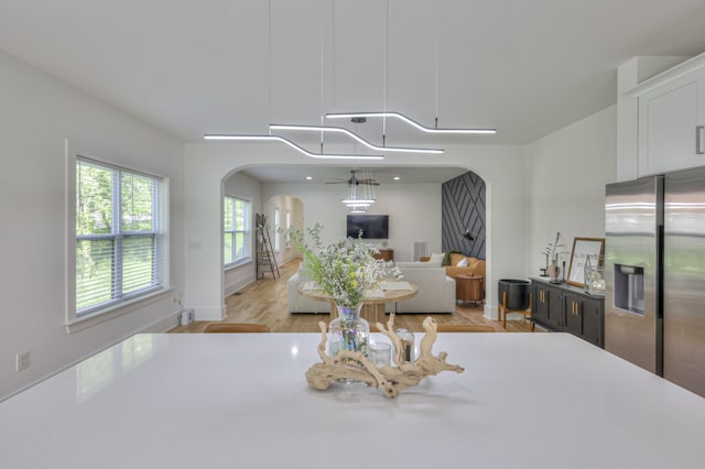 dining area featuring ceiling fan and light hardwood / wood-style flooring