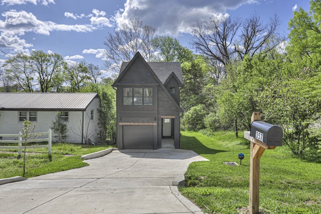 view of front of property with a front yard and a garage