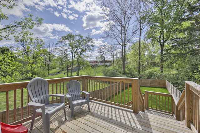 wooden terrace featuring a lawn