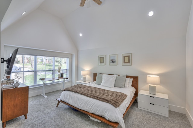 bedroom with ceiling fan, high vaulted ceiling, and light colored carpet