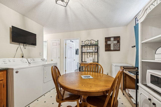 dining room featuring independent washer and dryer and a textured ceiling