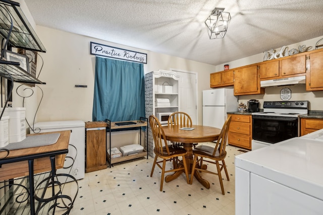 kitchen featuring a textured ceiling and white appliances