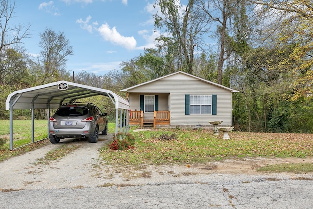 view of front of house with a front yard, a porch, and a carport