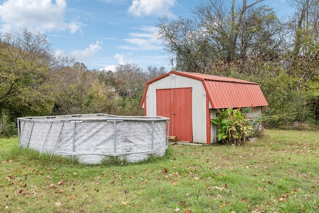 view of outbuilding with a yard