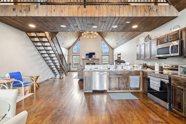 kitchen with high vaulted ceiling, dark hardwood / wood-style flooring, wooden ceiling, and appliances with stainless steel finishes