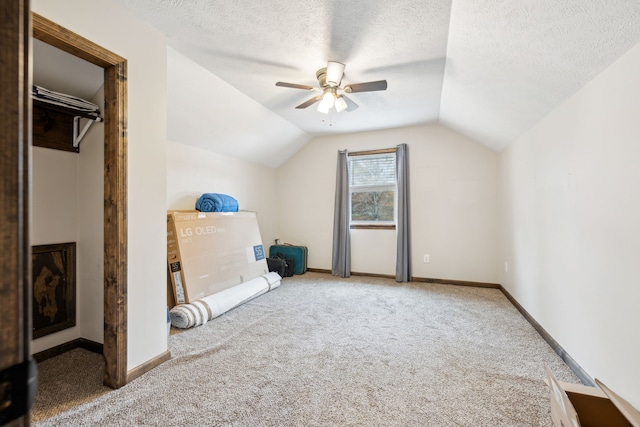 additional living space featuring carpet flooring, ceiling fan, lofted ceiling, and a textured ceiling