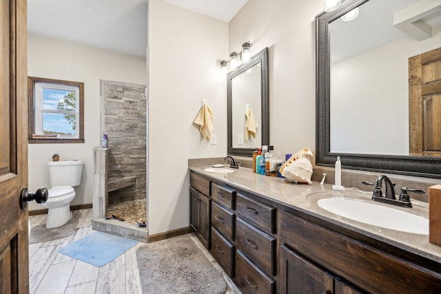 bathroom featuring walk in shower, vanity, and toilet