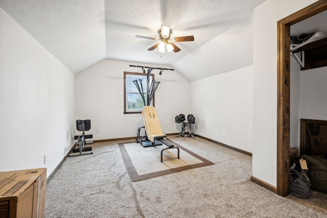 exercise area with a textured ceiling, carpet floors, ceiling fan, and lofted ceiling