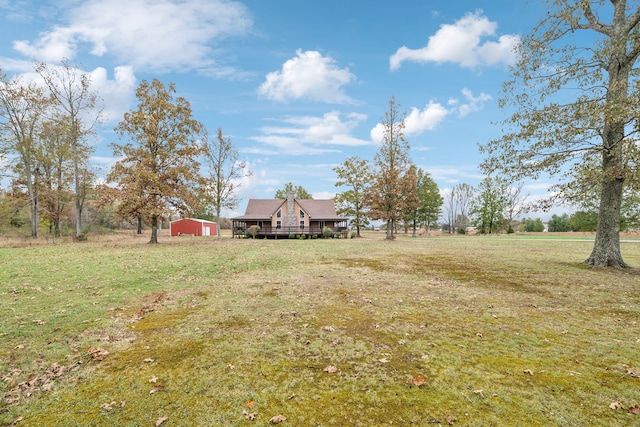 view of yard featuring a rural view and an outdoor structure