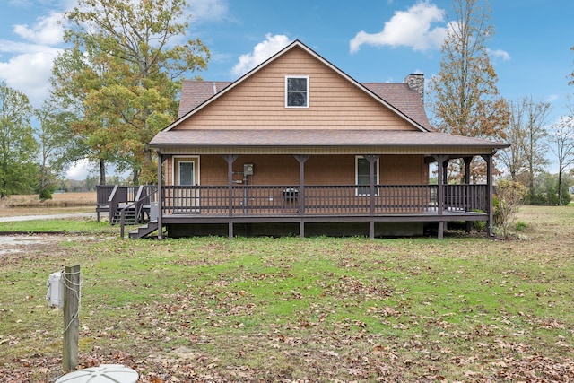 rear view of house with a yard