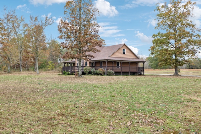 rear view of house featuring a yard