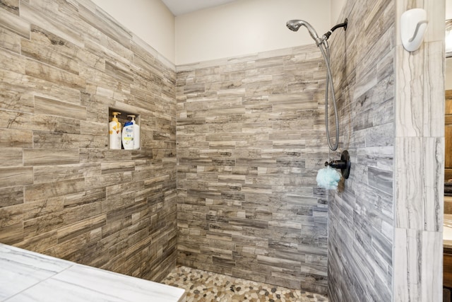 bathroom with a tile shower