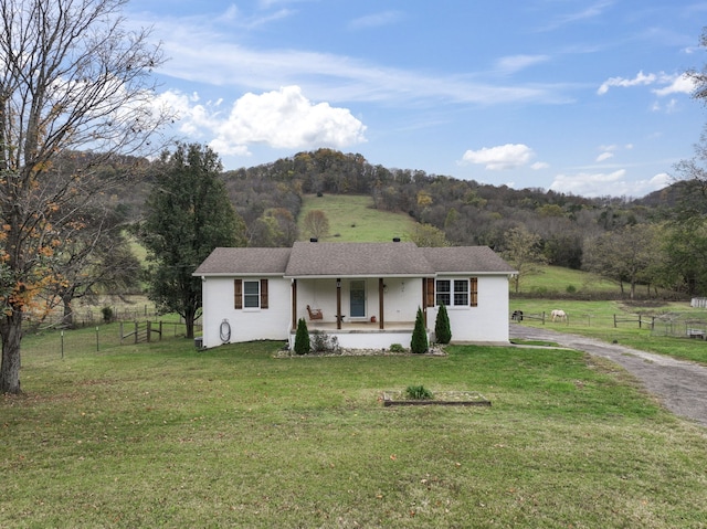 ranch-style home featuring covered porch and a front yard