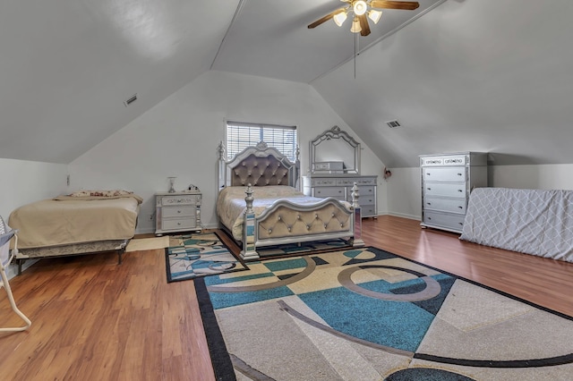 bedroom with ceiling fan, wood-type flooring, and vaulted ceiling