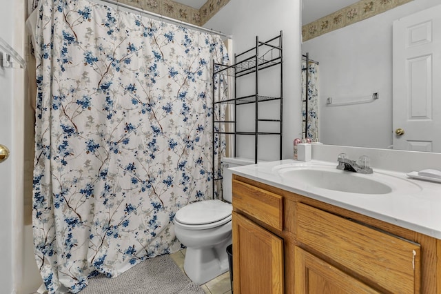 bathroom featuring tile patterned floors, vanity, curtained shower, and toilet