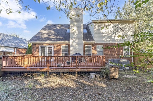 rear view of house featuring a wooden deck